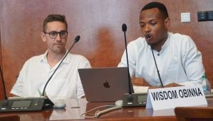 Obinna speaks at a microphone