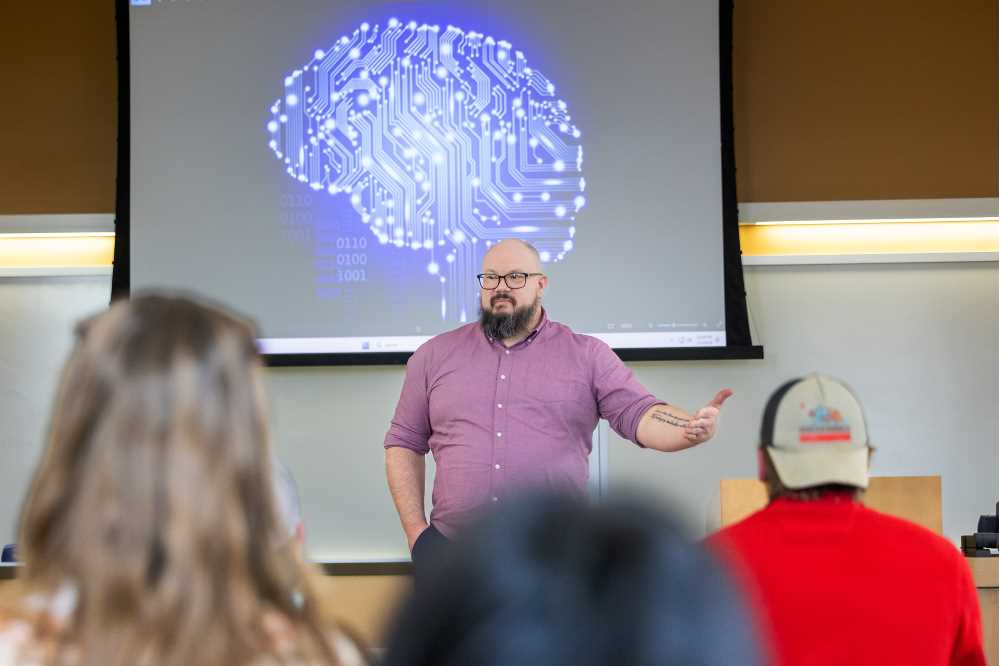 Photo of Stewart Eskew, assistant teaching professor of Philosophy, teaching a philosophy class at UW-La Crosse. The AI Ethics Certificate program will be housed within the Philosophy Department. Artificial intelligence (AI) ethics is a branch of ethics that explores complex ethical challenges posed by AI technologies.